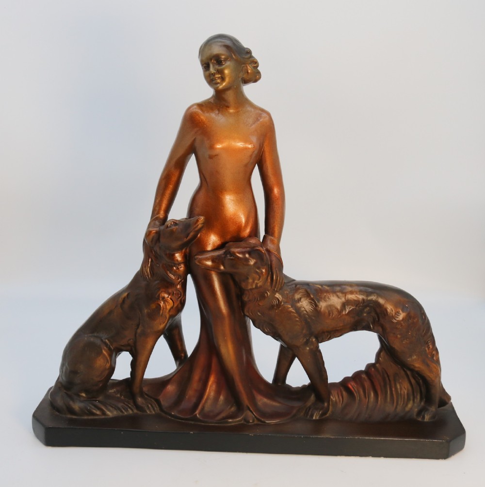 An elegant art deco plaster and cold painted figure group, circa 1930
