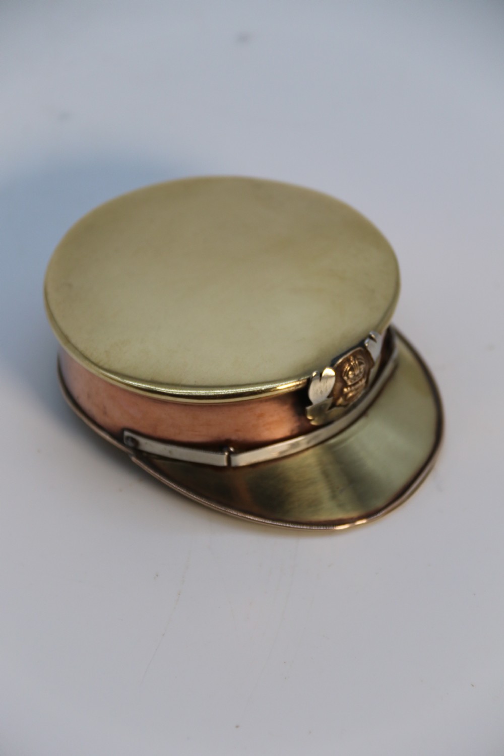 A rare novelty pocket snuff box in the form of an English naval officers peaked cap. View XV