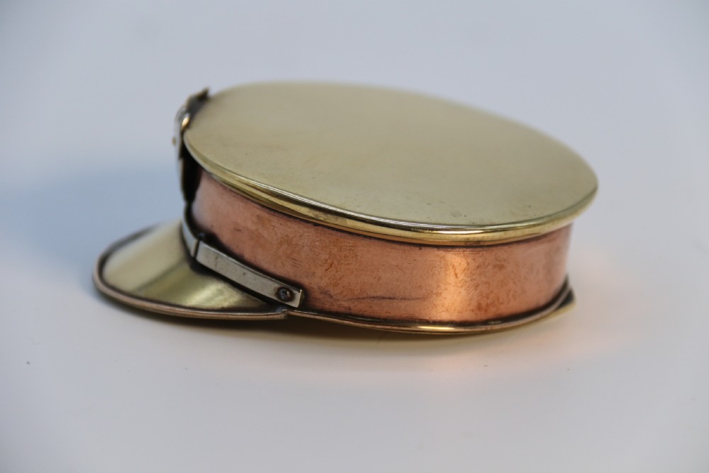 A rare novelty pocket snuff box in the form of an English naval officers peaked cap. View XVII