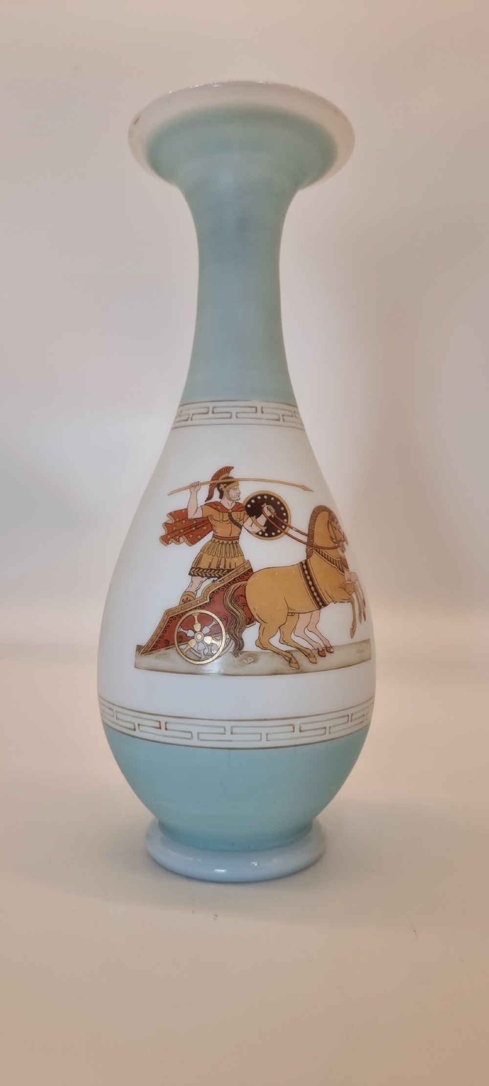A late nineteenth-century opaque white and light blue glass vase decorated with a hand-painted scene of a Greek chariot and warrior bordered by Greek key patterns. View VI