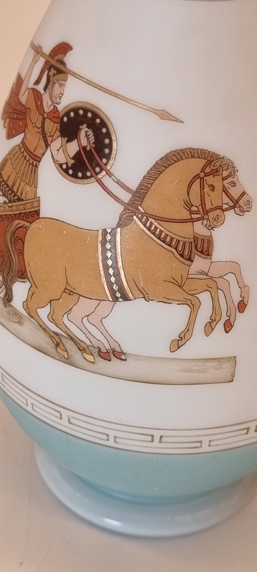 A late nineteenth-century opaque white and light blue glass vase decorated with a hand-painted scene of a Greek chariot and warrior bordered by Greek key patterns. View XI