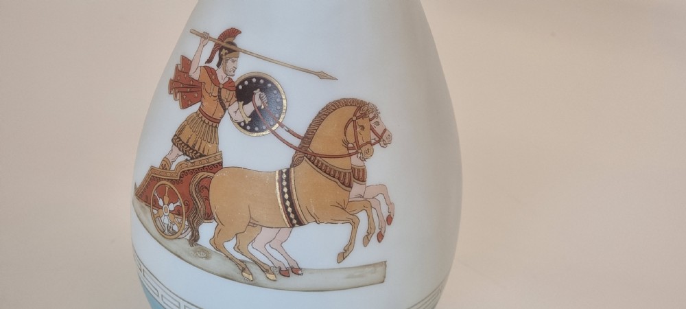 A late nineteenth-century opaque white and light blue glass vase decorated with a hand-painted scene of a Greek chariot and warrior bordered by Greek key patterns. View XIV