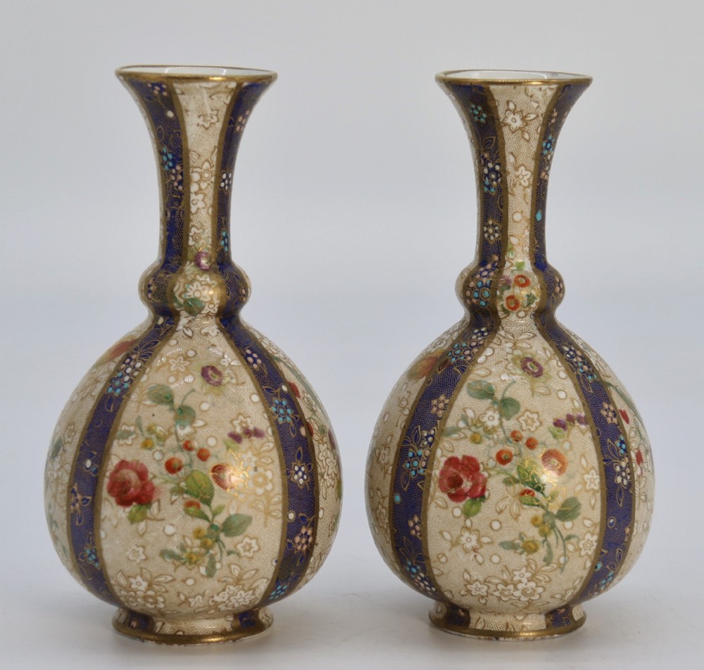 A pair of early Carlton Ware enamelled and gilt floral vases, circa 1900