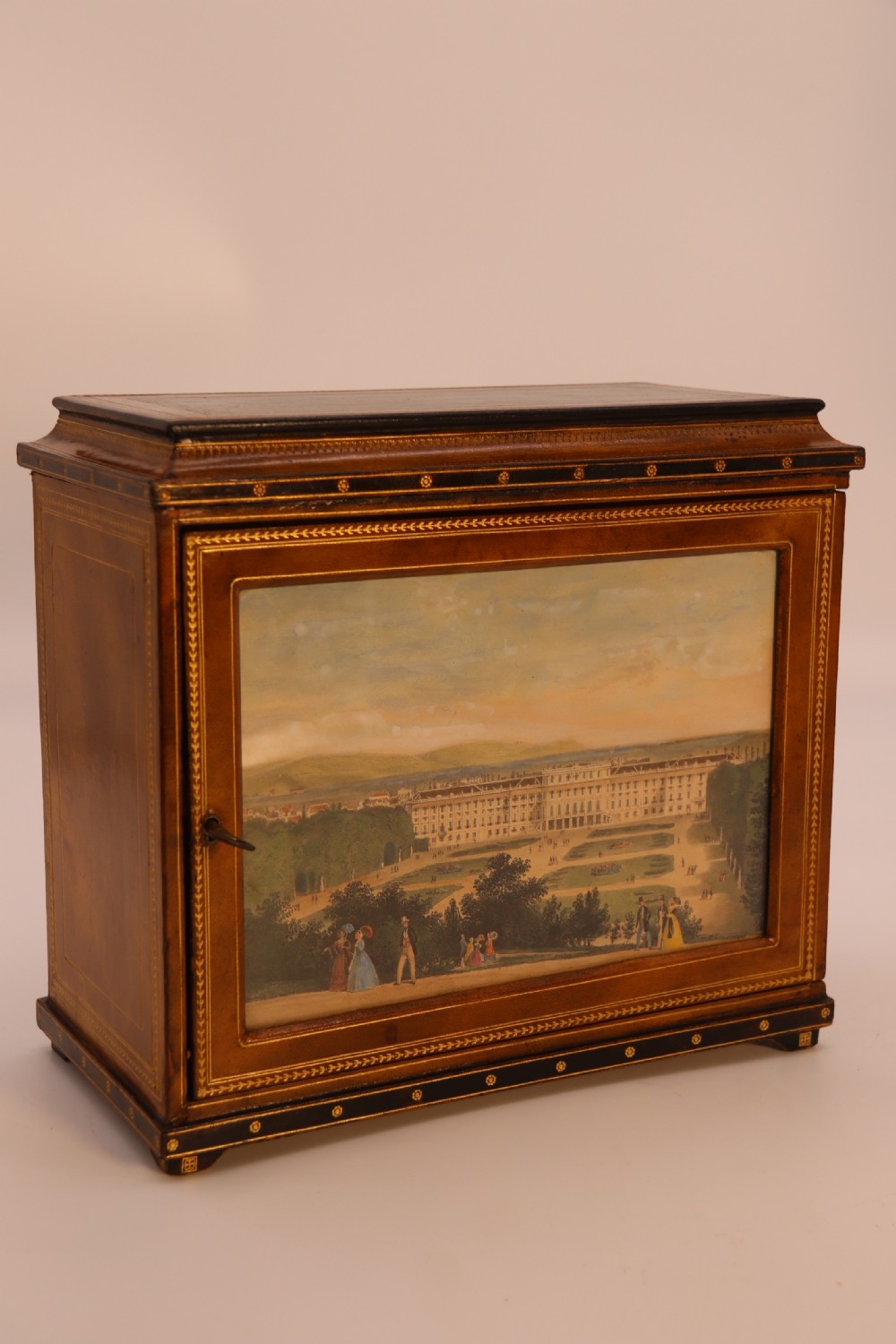 An Italian Grand Tour late 19th century jewellery cabinet finished in gilt tooled leather with a hand coloured view of The Royal Palace, Caserta Italy.

 View XX