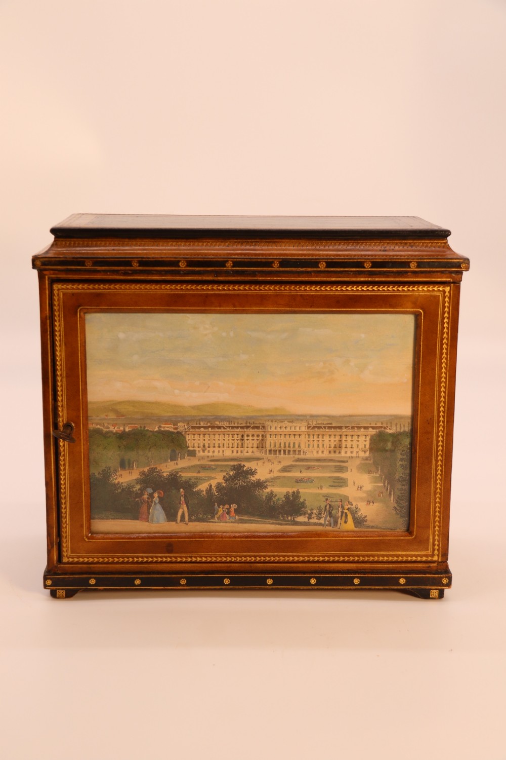 An Italian Grand Tour late 19th century jewellery cabinet finished in gilt tooled leather with a hand coloured view of The Royal Palace, Caserta Italy.

 View XXII