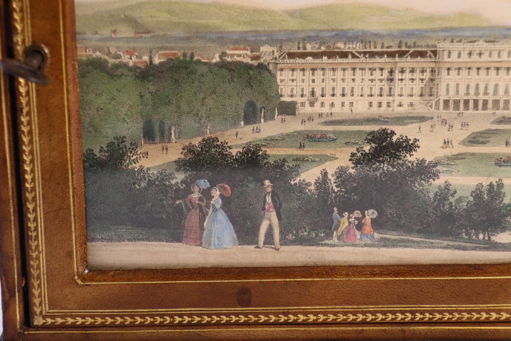 An Italian Grand Tour late 19th century jewellery cabinet finished in gilt tooled leather with a hand coloured view of The Royal Palace, Caserta Italy.

 View XXVI