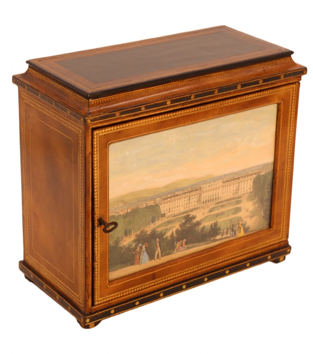 An Italian Grand Tour late 19th century jewellery cabinet finished in gilt tooled leather with a hand coloured view of The Royal Palace, Caserta Italy.

