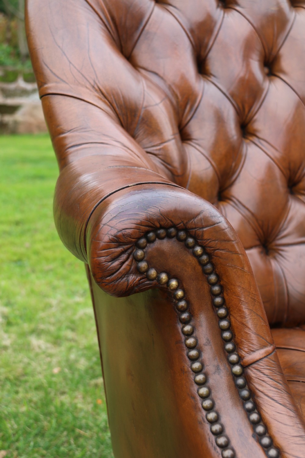 An English tilt and rotate desk/study armchair upholstered in original deep buttoned leather. View XXII