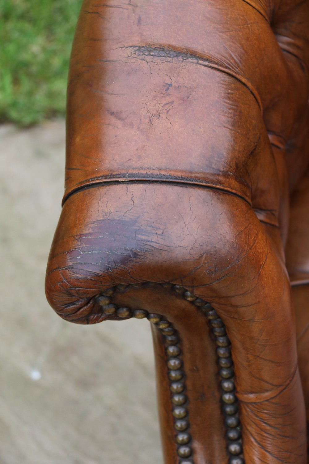 An English tilt and rotate desk/study armchair upholstered in original deep buttoned leather. View XXIII