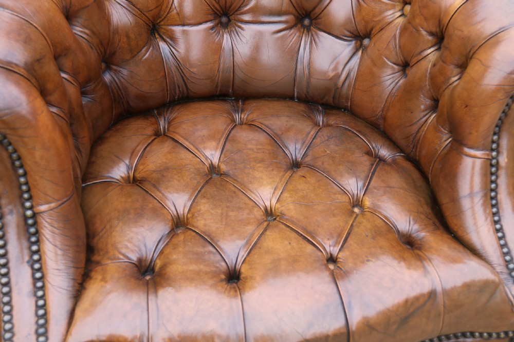 An English tilt and rotate desk/study armchair upholstered in original deep buttoned leather. View XXV