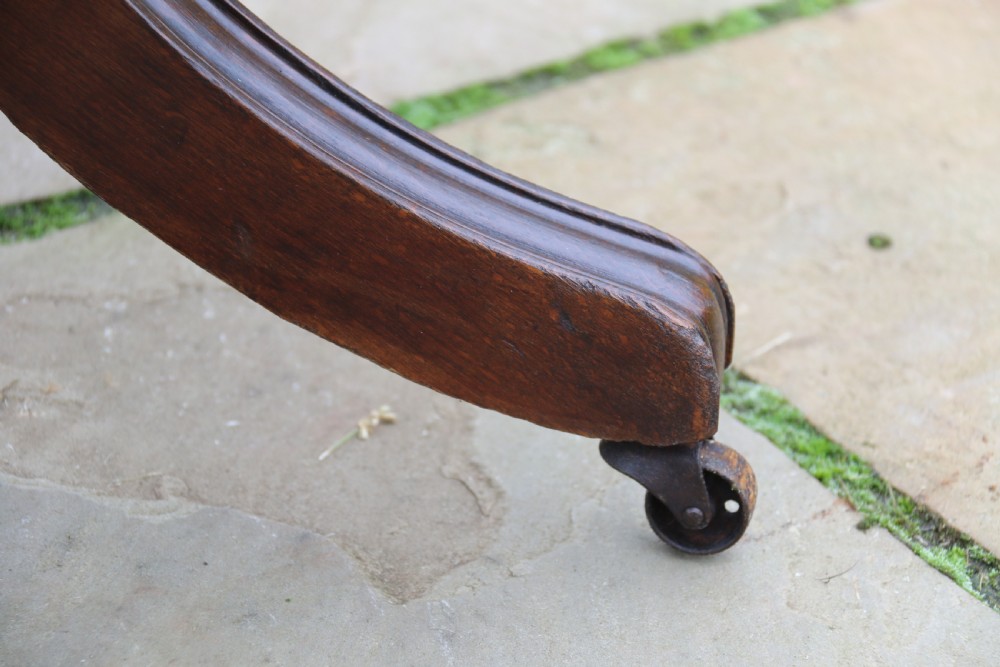 An English tilt and rotate desk/study armchair upholstered in original deep buttoned leather. View XXX