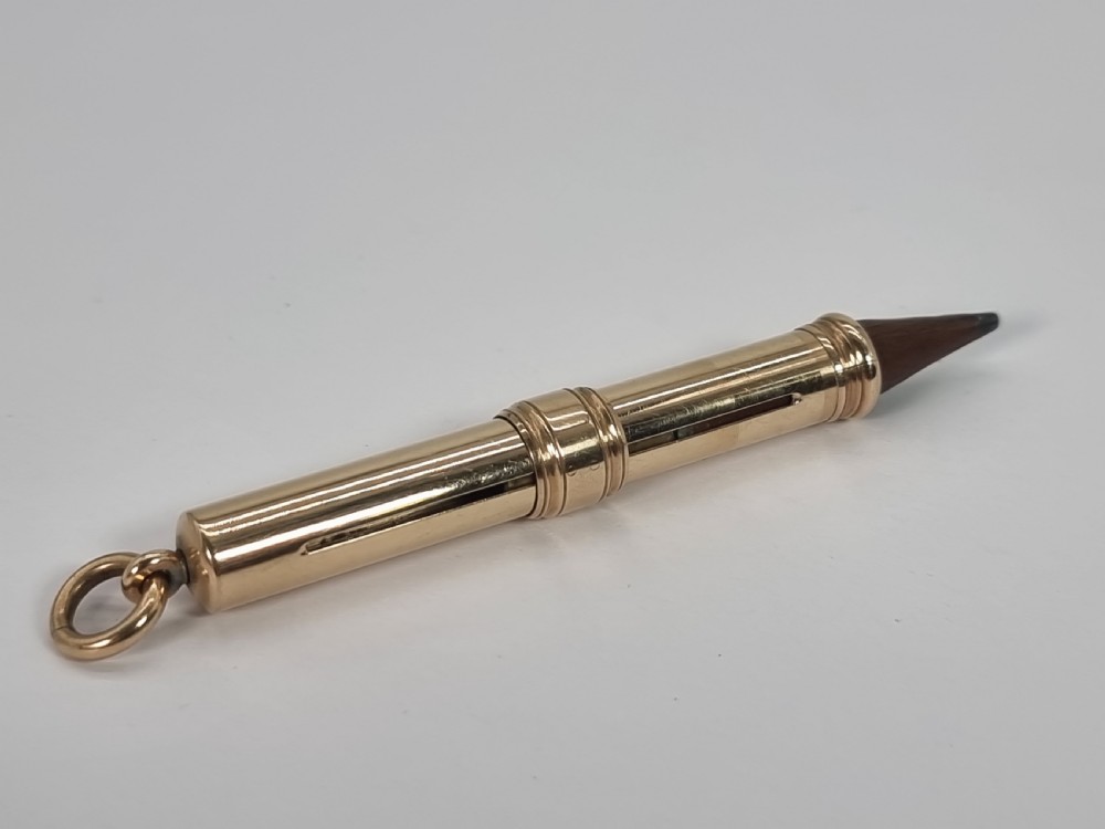A late 19th century 10ct gold Mordan and Co. sliding fob pencil. View IV