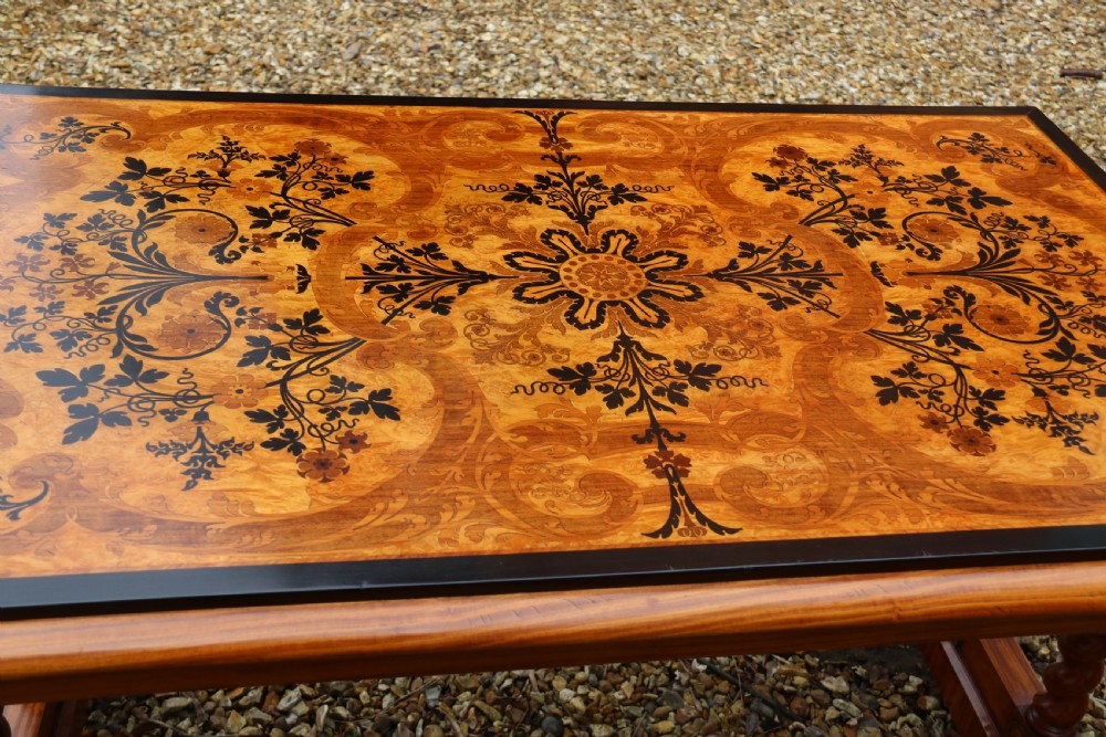 A rectangular mid-19th century satinwood centre table featuring detailed floral marquetry inlay across the tabletop, supported by carved barley twist legs and a central stretcher. View VII