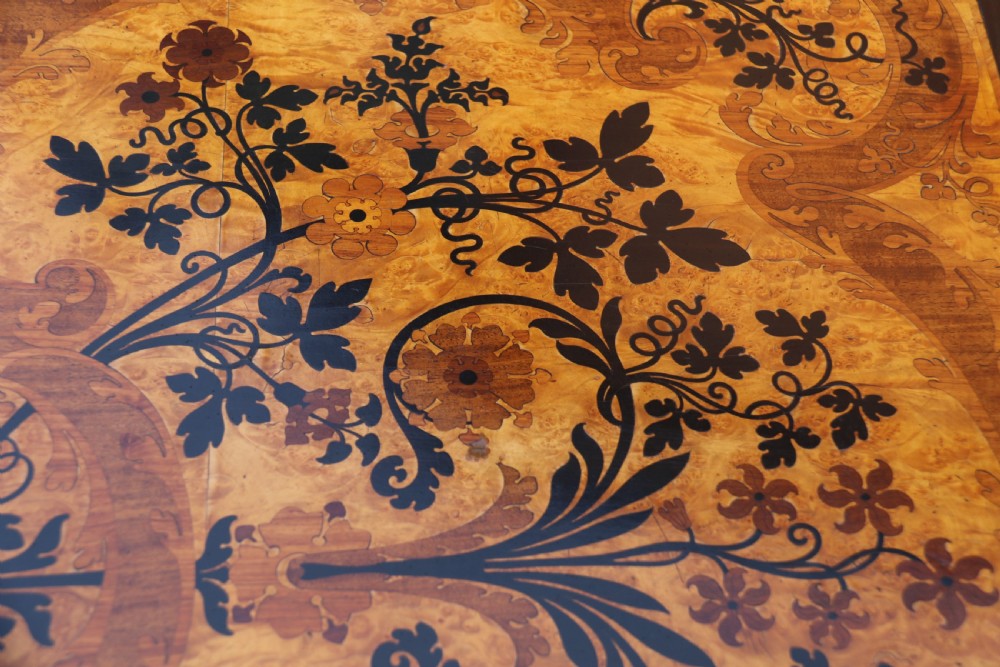 A rectangular mid-19th century satinwood centre table featuring detailed floral marquetry inlay across the tabletop, supported by carved barley twist legs and a central stretcher. View XI