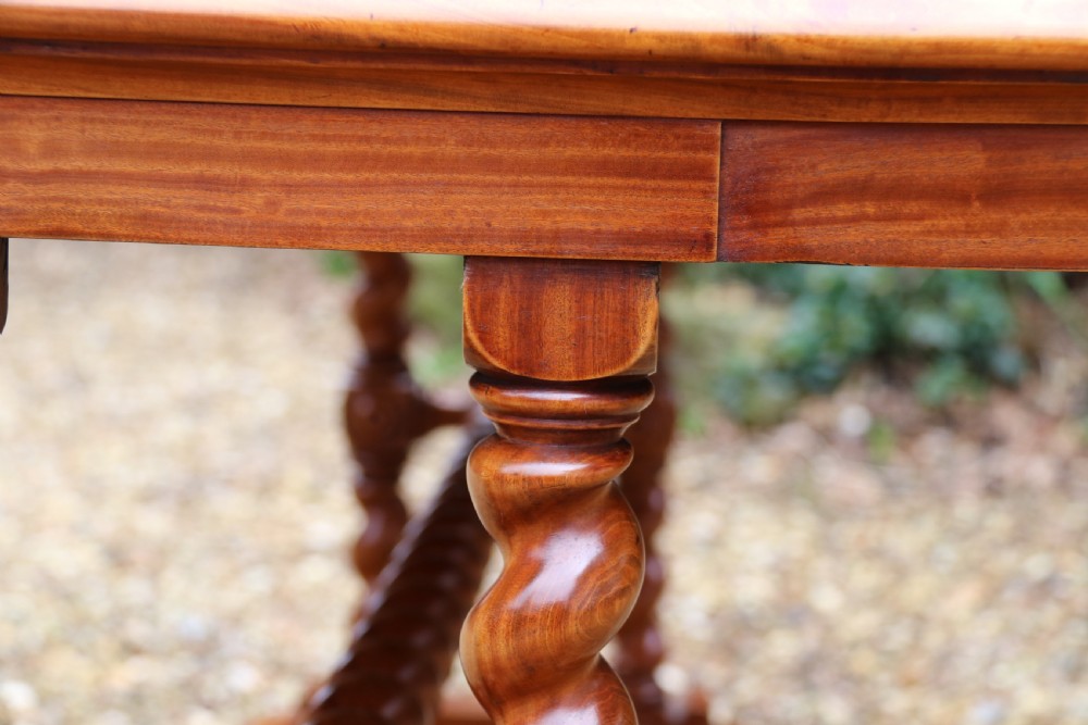 A rectangular mid-19th century satinwood centre table featuring detailed floral marquetry inlay across the tabletop, supported by carved barley twist legs and a central stretcher. View XII
