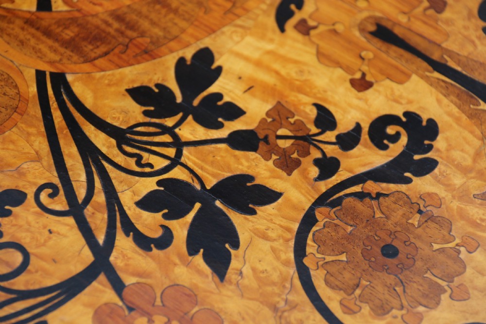 A rectangular mid-19th century satinwood centre table featuring detailed floral marquetry inlay across the tabletop, supported by carved barley twist legs and a central stretcher. View XVII
