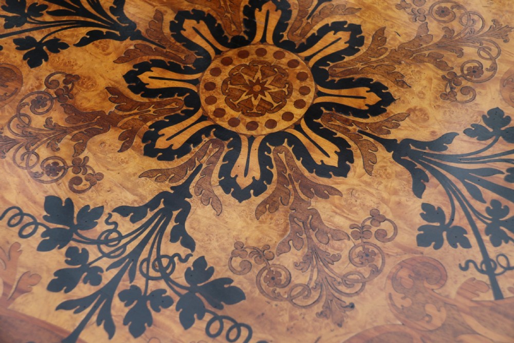 A rectangular mid-19th century satinwood centre table featuring detailed floral marquetry inlay across the tabletop, supported by carved barley twist legs and a central stretcher. View XX