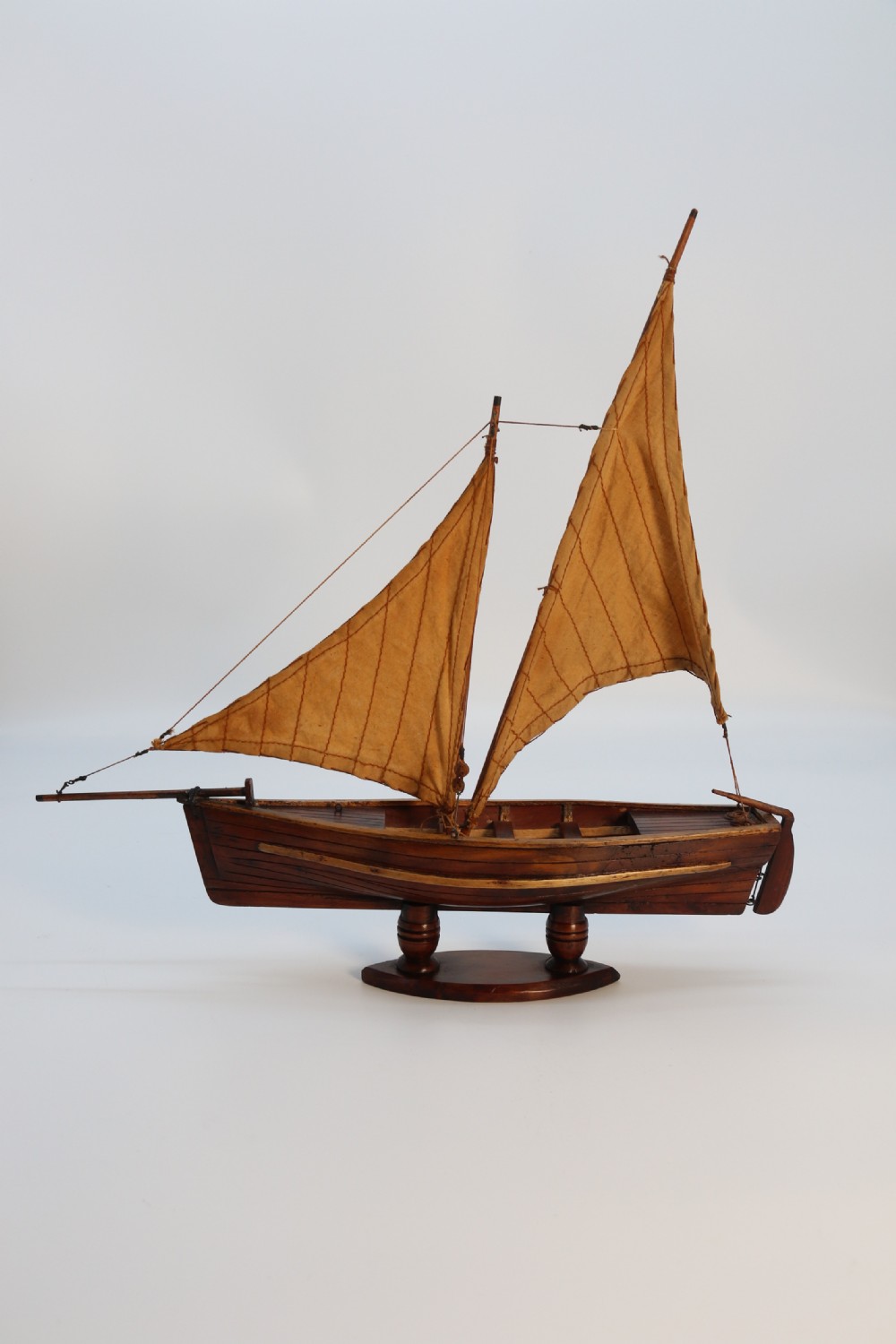 An English handmade yew wood model of an elegant 19th century sailing boat.