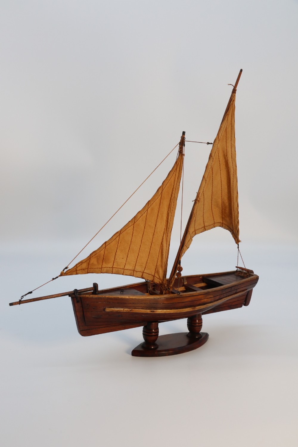 An English handmade yew wood model of an elegant 19th century sailing boat. View II