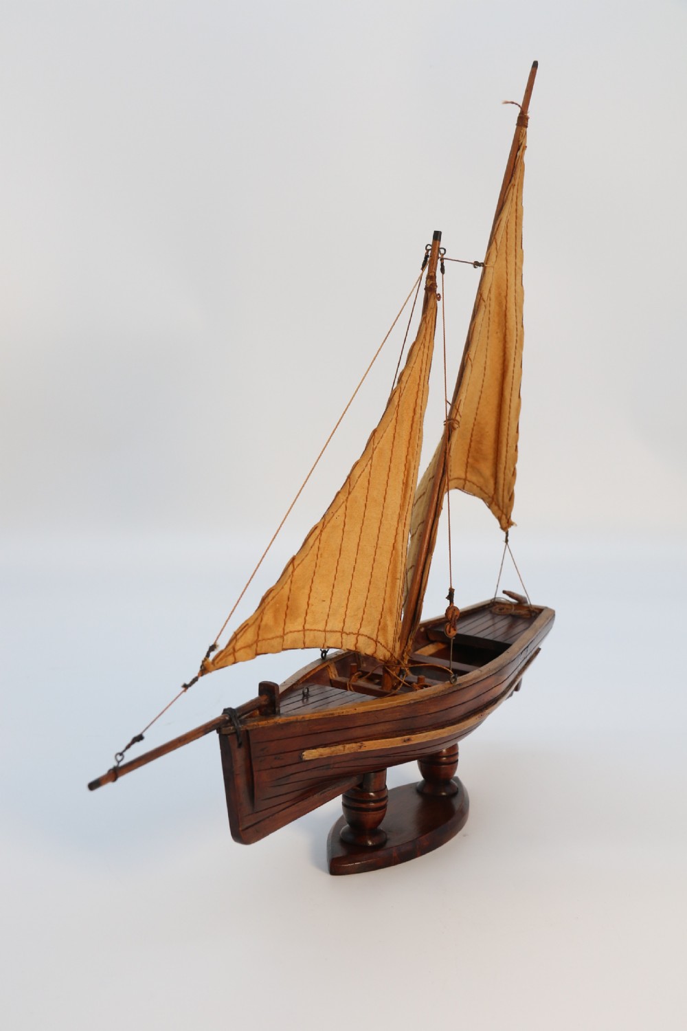 An English handmade yew wood model of an elegant 19th century sailing boat. View III