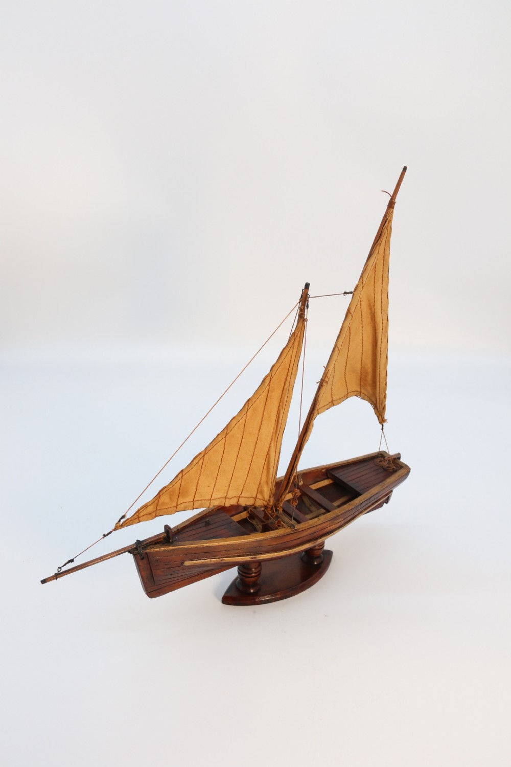 An English handmade yew wood model of an elegant 19th century sailing boat. View X