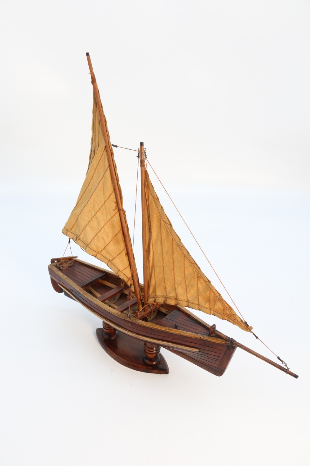 An English handmade yew wood model of an elegant 19th century sailing boat. View XI