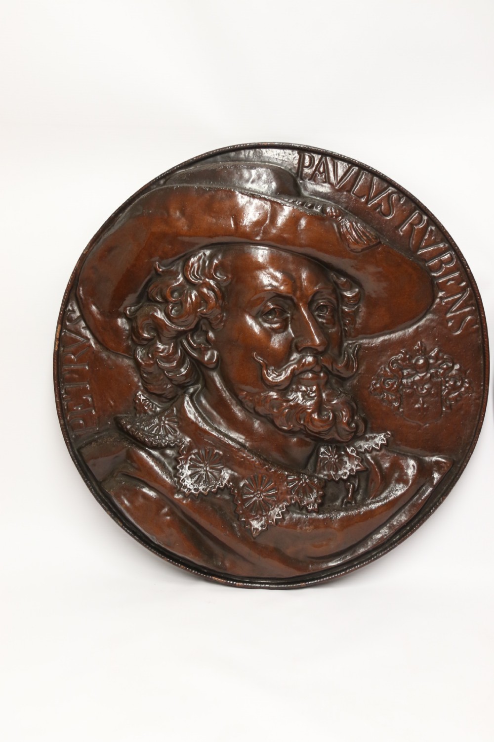 A matched pair of circular dark brown cast iron relief plaques featuring high-relief portrait busts of Peter Paul Rubens and William Shakespeare. View II