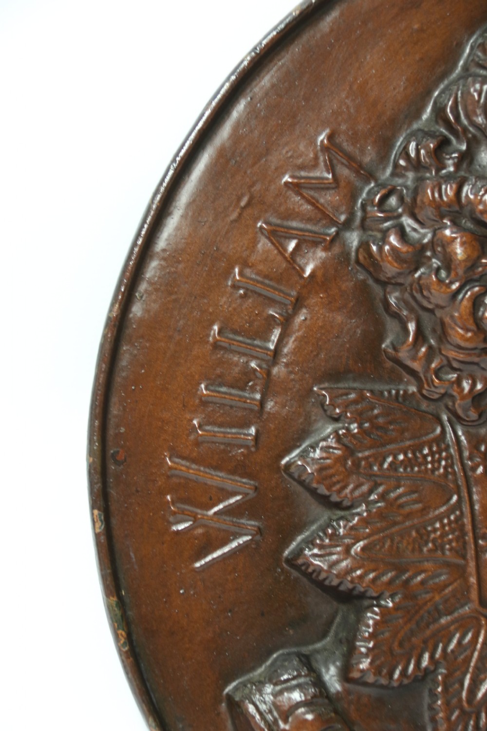 A matched pair of circular dark brown cast iron relief plaques featuring high-relief portrait busts of Peter Paul Rubens and William Shakespeare. View X