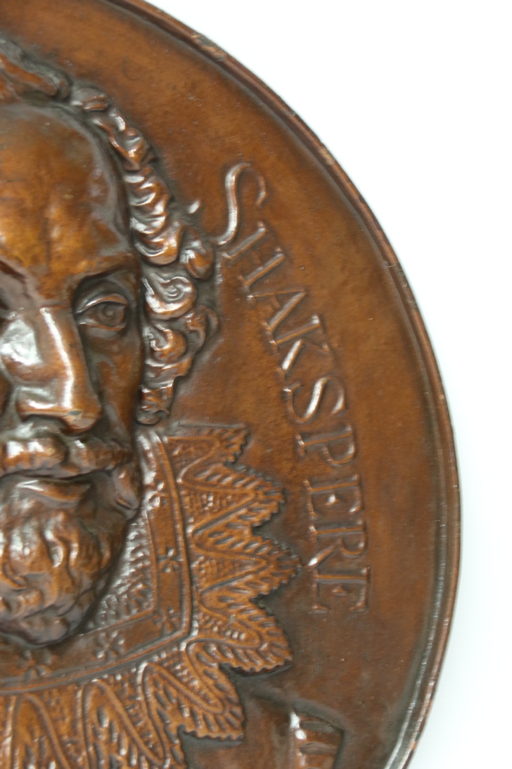 A matched pair of circular dark brown cast iron relief plaques featuring high-relief portrait busts of Peter Paul Rubens and William Shakespeare. View XI