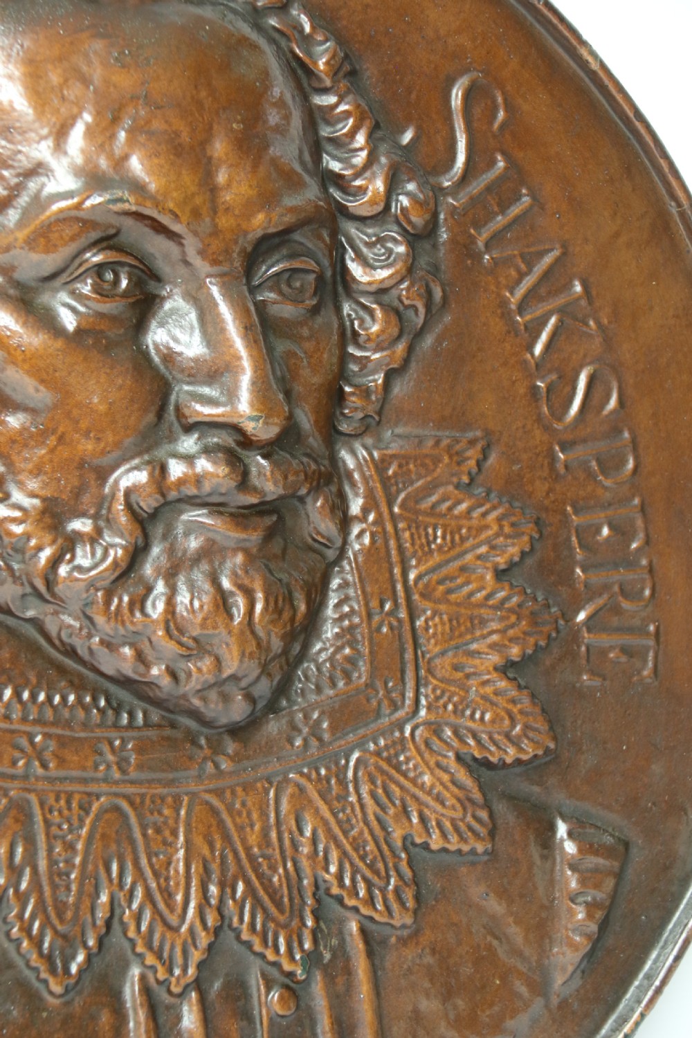 A matched pair of circular dark brown cast iron relief plaques featuring high-relief portrait busts of Peter Paul Rubens and William Shakespeare. View XVI