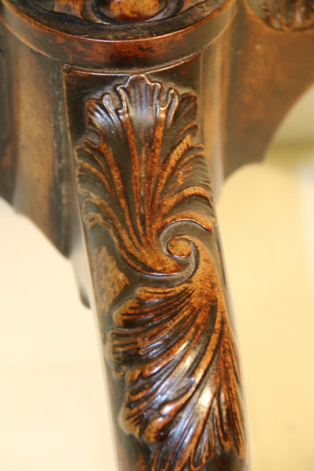 An antique Chippendale mahogany candle stand featuring an octagonal top with a pierced fretwork gallery, a fluted column, and carved tripod legs. View VI
