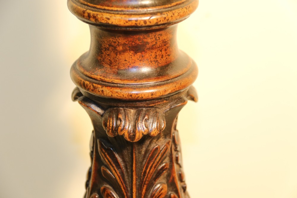 An antique Chippendale mahogany candle stand featuring an octagonal top with a pierced fretwork gallery, a fluted column, and carved tripod legs. View IX