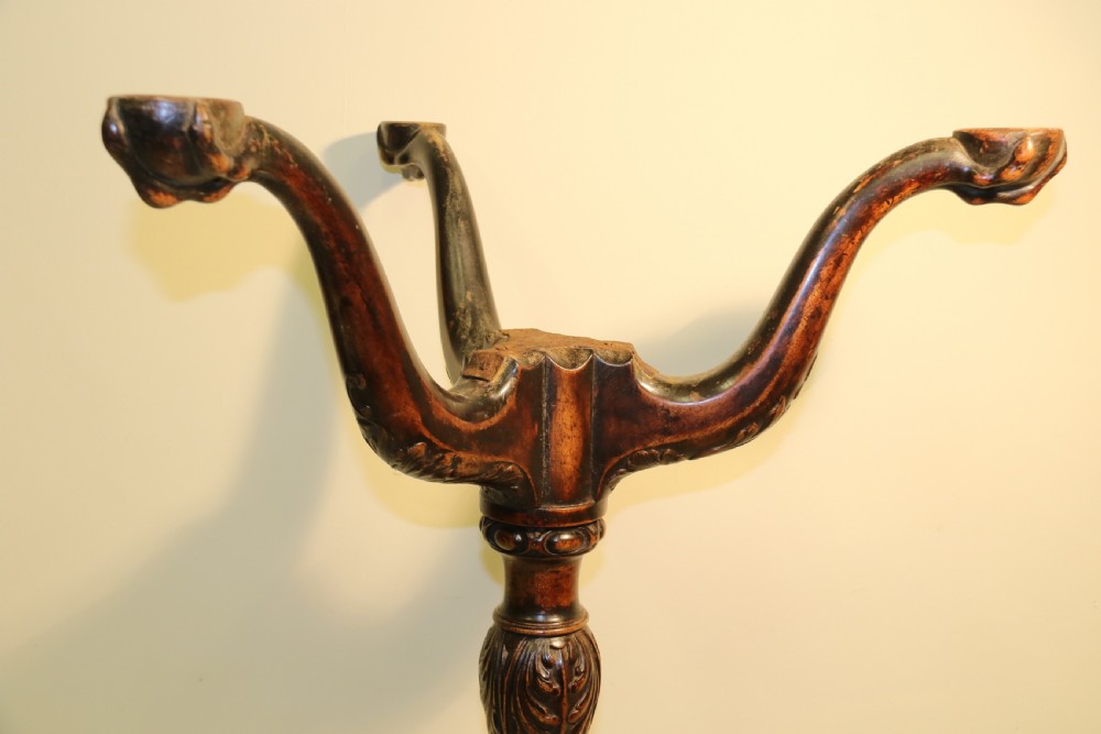 An antique Chippendale mahogany candle stand featuring an octagonal top with a pierced fretwork gallery, a fluted column, and carved tripod legs. View X