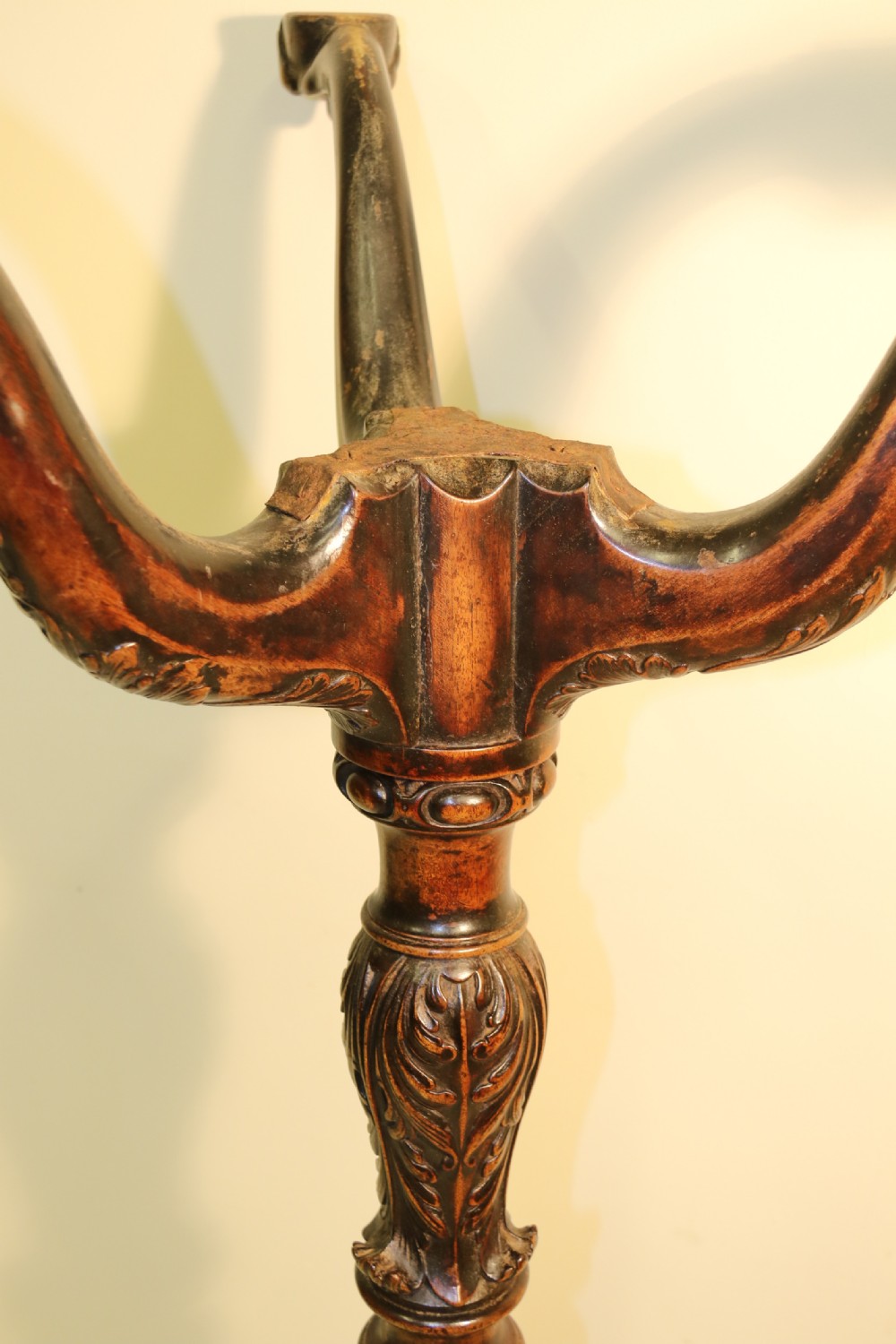 An antique Chippendale mahogany candle stand featuring an octagonal top with a pierced fretwork gallery, a fluted column, and carved tripod legs. View XI