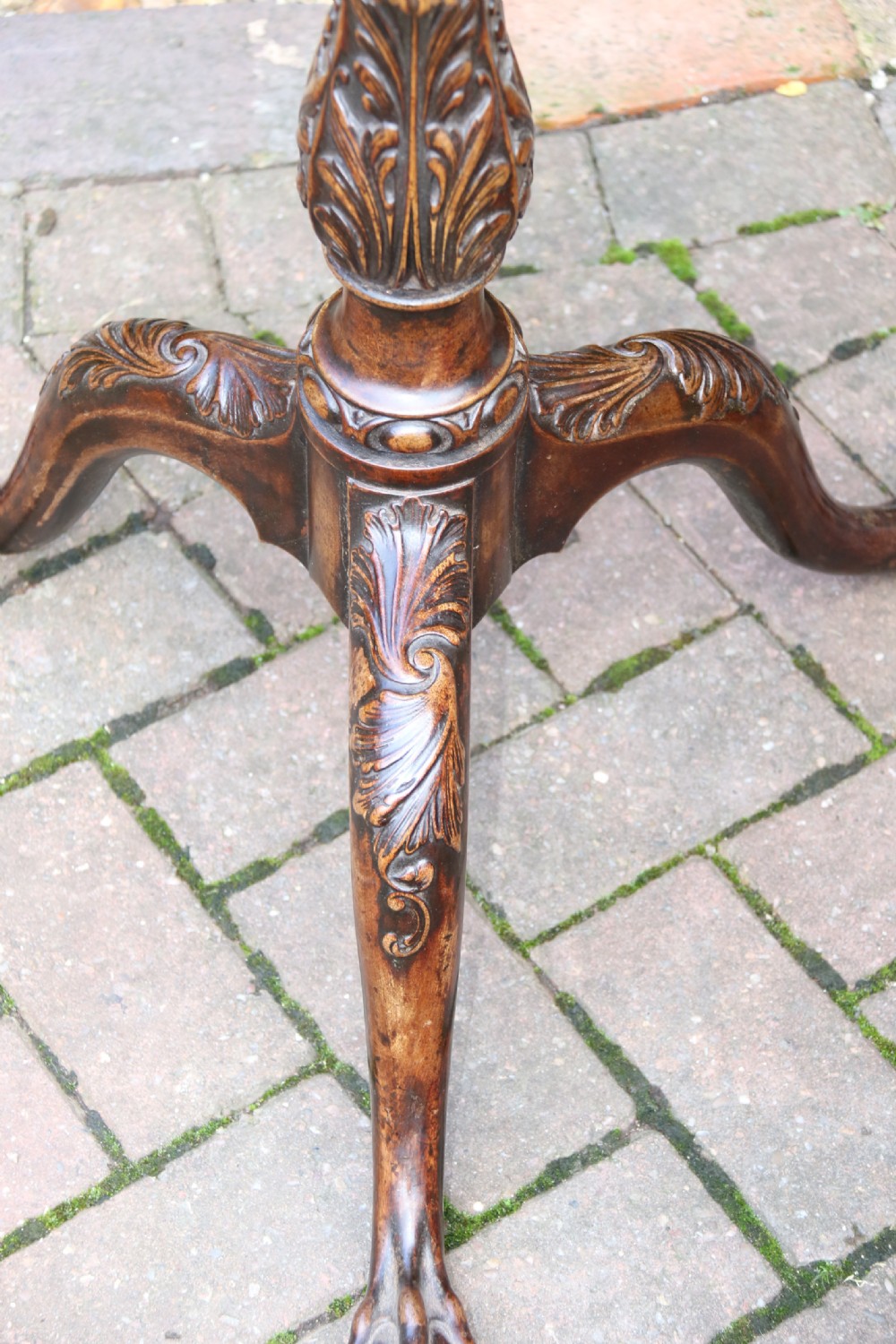 An antique Chippendale mahogany candle stand featuring an octagonal top with a pierced fretwork gallery, a fluted column, and carved tripod legs. View XIX