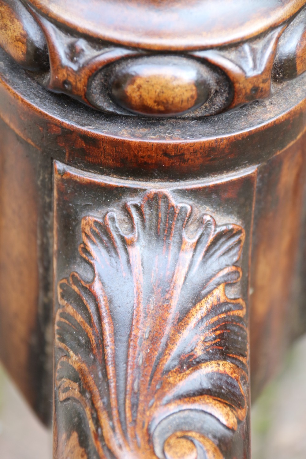 An antique Chippendale mahogany candle stand featuring an octagonal top with a pierced fretwork gallery, a fluted column, and carved tripod legs. View XXIII