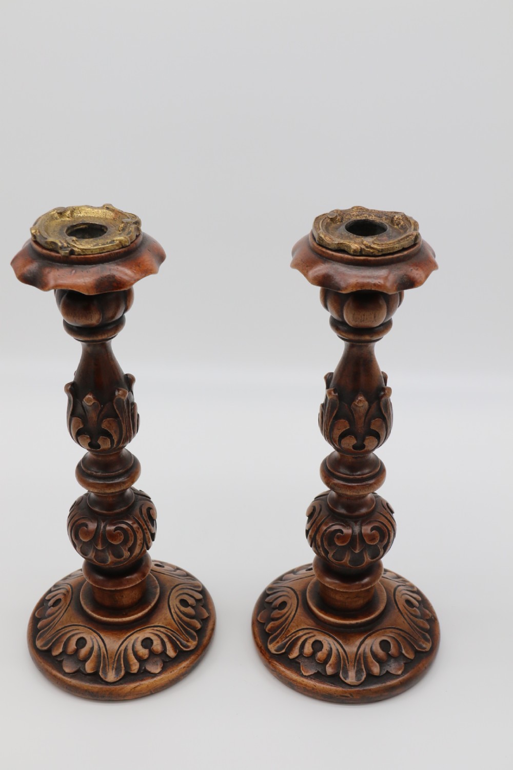 A large scale pair of English 19th century carved walnut and brass mounted candlesticks View V