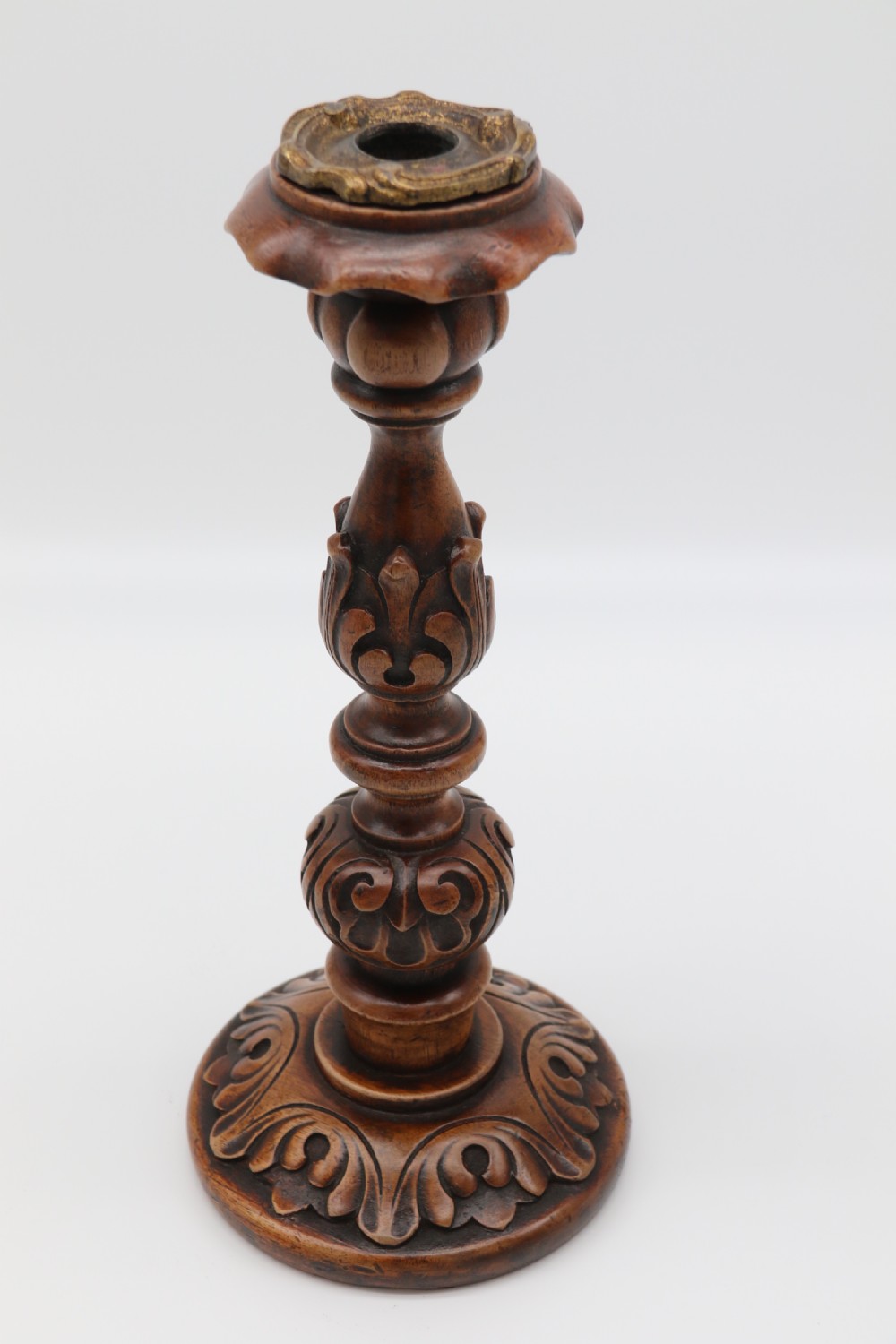 A large scale pair of English 19th century carved walnut and brass mounted candlesticks View VI