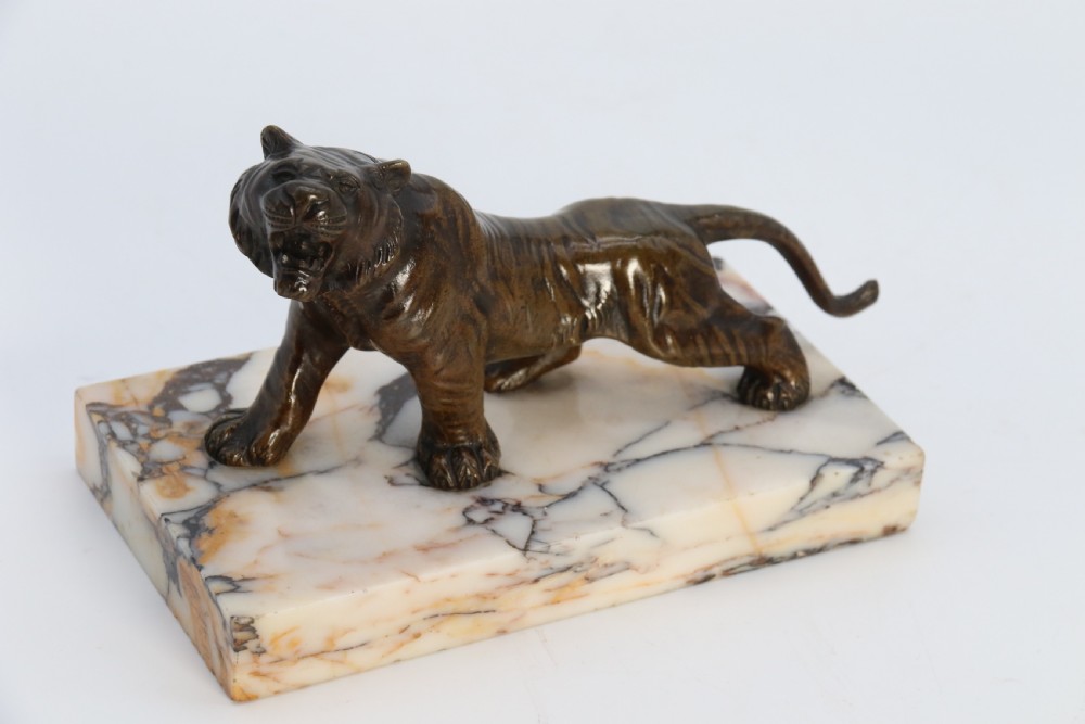 A dark bronze tiger sculpture posed in a roaring stance, mounted on a rectangular veined marble base. View IX