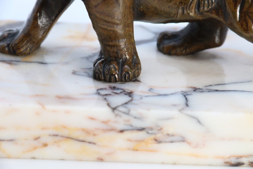 A dark bronze tiger sculpture posed in a roaring stance, mounted on a rectangular veined marble base. View XII
