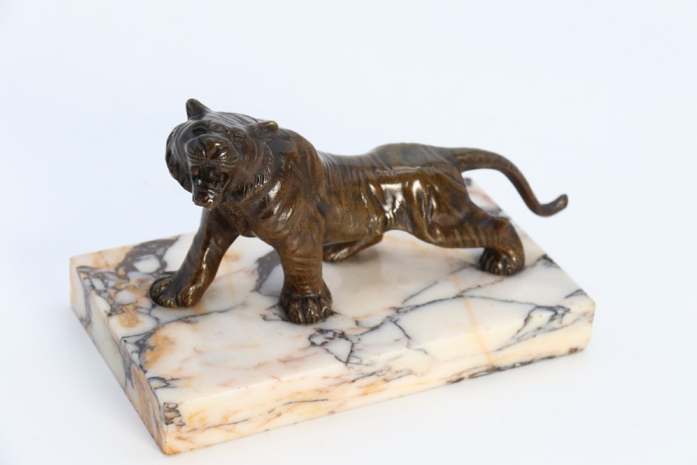 A dark bronze tiger sculpture posed in a roaring stance, mounted on a rectangular veined marble base. View XVIII