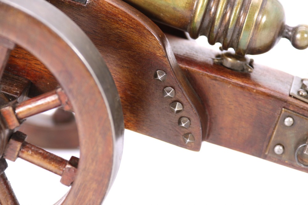 A detailed hand-built scale model of a 17th-century field cannon featuring a patinated brass barrel mounted on a dark timber carriage with spoked wheels. View XVIII