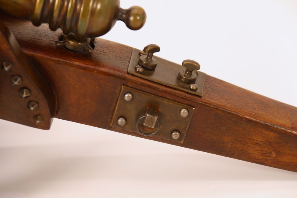 A detailed hand-built scale model of a 17th-century field cannon featuring a patinated brass barrel mounted on a dark timber carriage with spoked wheels. View XIX