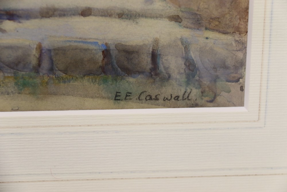 A framed 1920s watercolour landscape painting showing a stone building with vine foliage, set inside a decorative gilt frame with cream matting. View III
