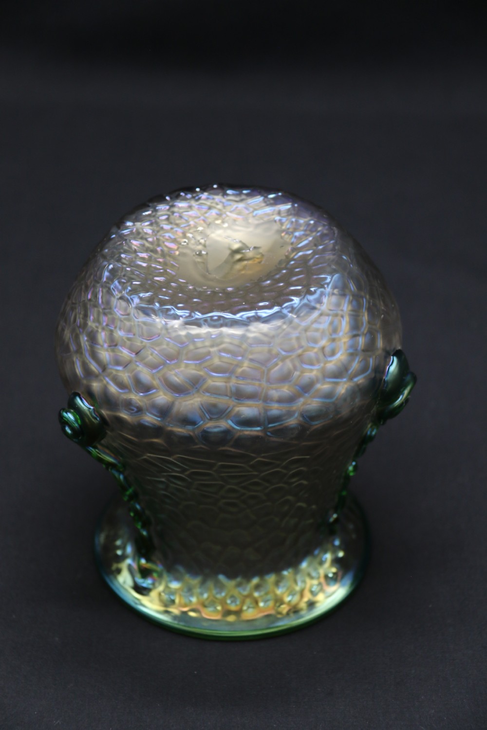 An Art Nouveau iridescent glass vase featuring a textured honeycomb pattern, a flared rim, and dark green applied glass trailings along the sides. View V