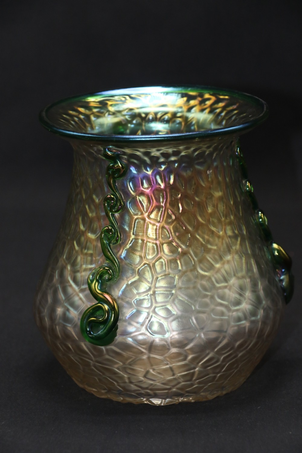 An Art Nouveau iridescent glass vase featuring a textured honeycomb pattern, a flared rim, and dark green applied glass trailings along the sides. View VIII