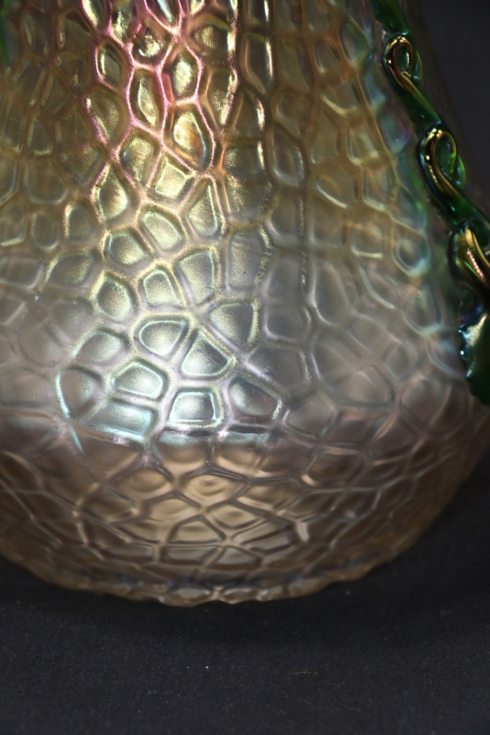 An Art Nouveau iridescent glass vase featuring a textured honeycomb pattern, a flared rim, and dark green applied glass trailings along the sides. View XIII