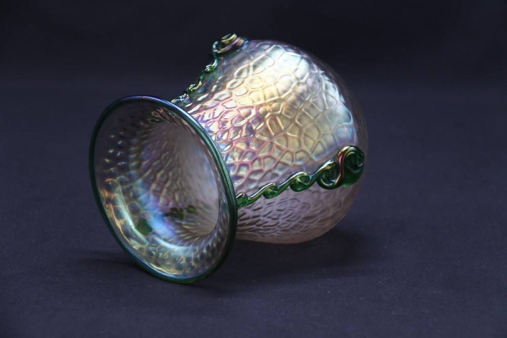 An Art Nouveau iridescent glass vase featuring a textured honeycomb pattern, a flared rim, and dark green applied glass trailings along the sides. View XIV
