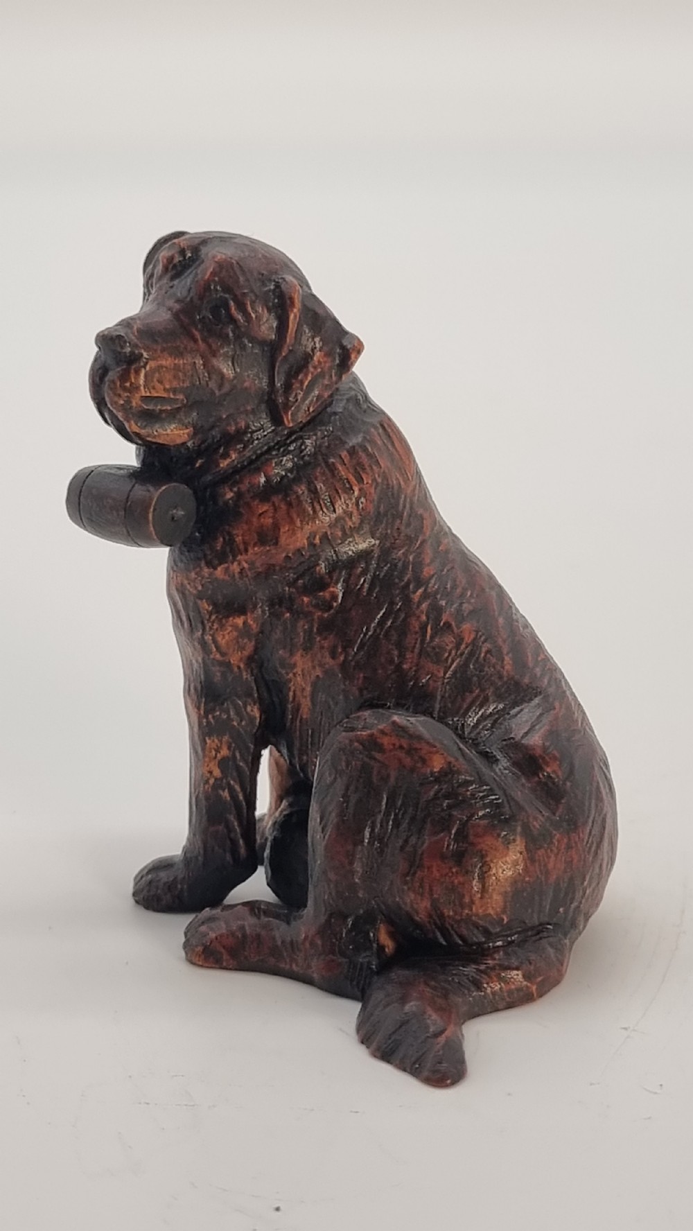 Antique hand carved study of Black Forest lime wood seated St. Bernard rescue dog View III