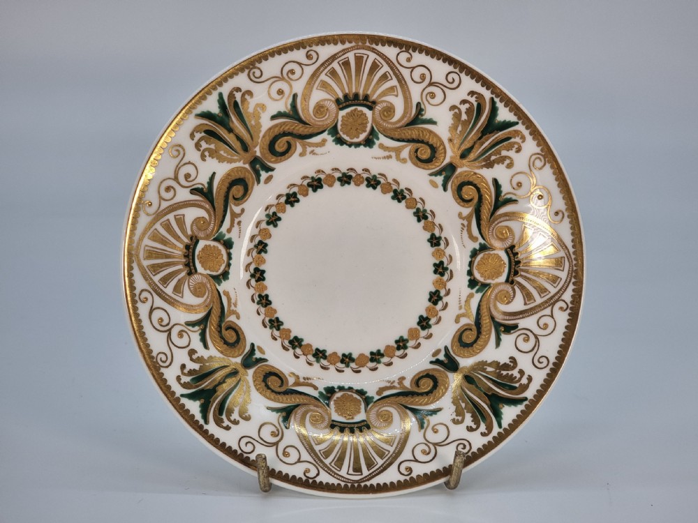 An early 19th-century Spode porcelain cabinet trio consisting of a teacup, coffee cup, and saucer adorned with intricate gold gilding and green scrollwork. View II